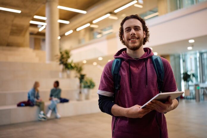 Happy college student looking at camera.